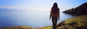 woman alone staring out at the sunshine/sea